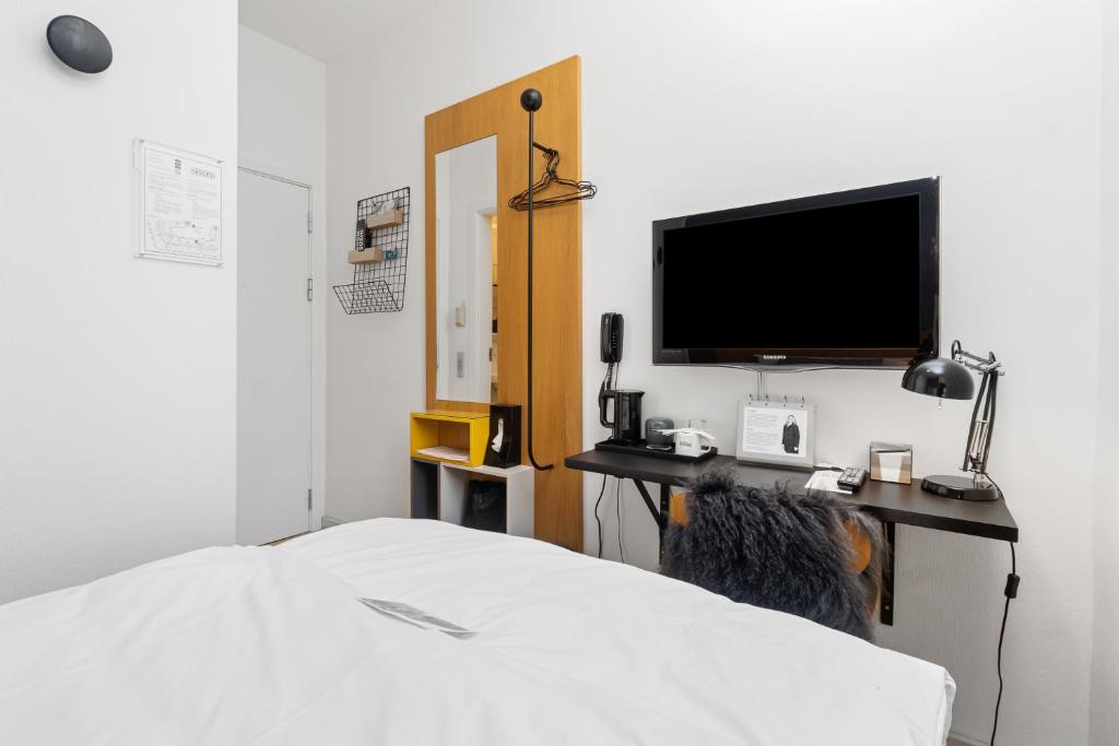 Postel nebo postele na pokoji v ubytování Ibsens Hotel
