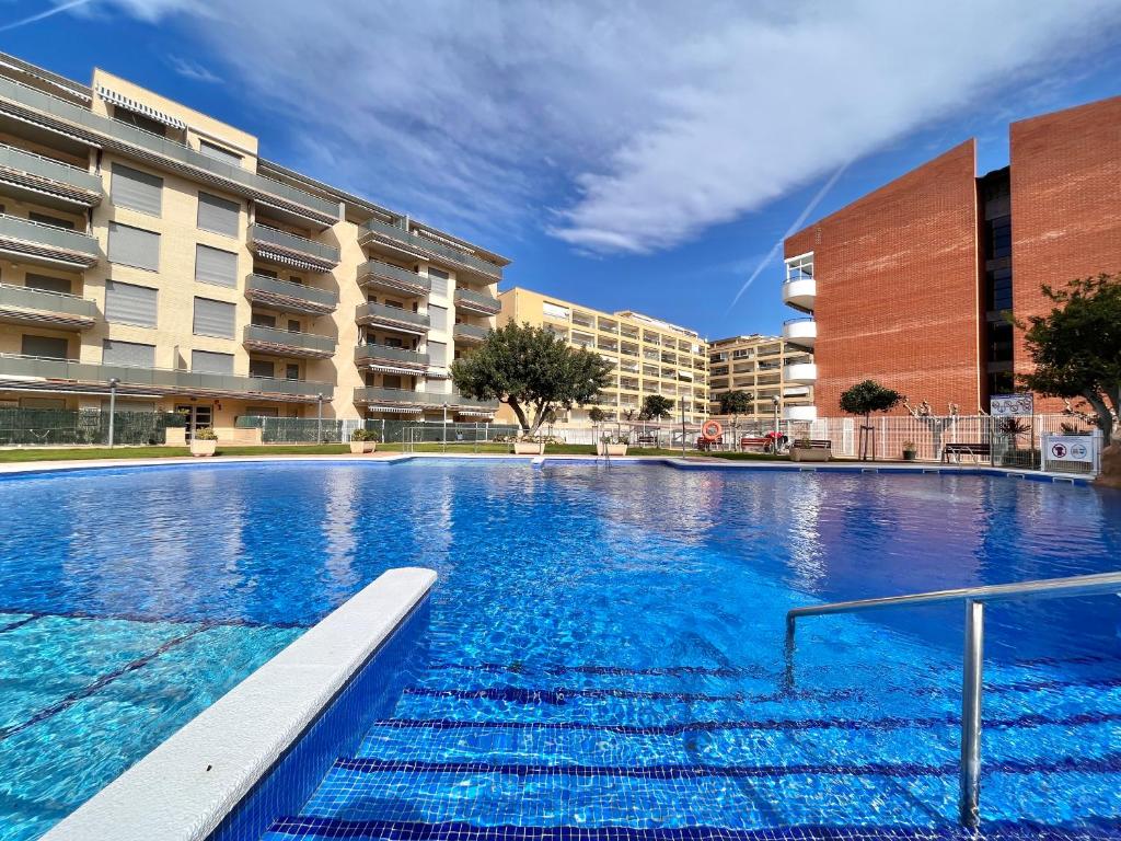 a large swimming pool in front of a building at Mediterranean Way - Maldivas in La Pineda