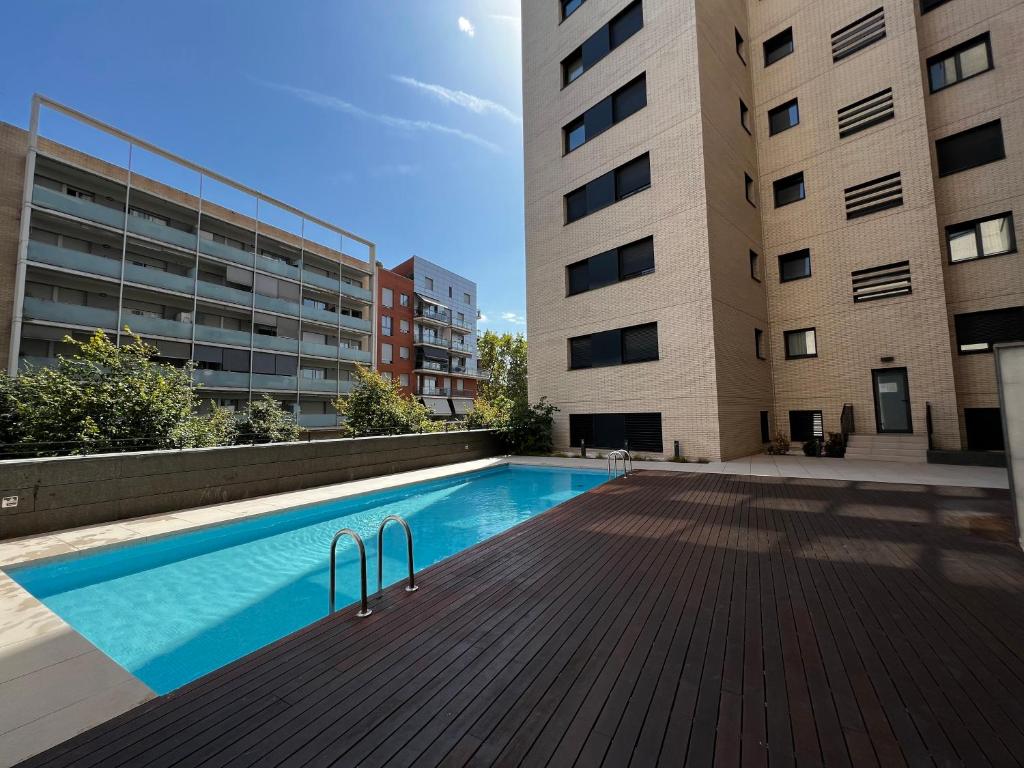 a swimming pool in front of a building at Apartment CP Poblenou in Barcelona