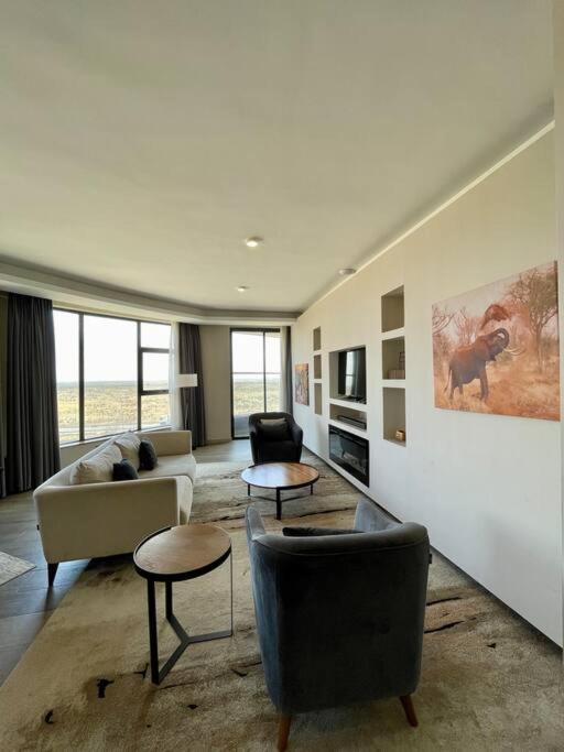 a living room with couches and tables in a room at A Scenic Escape within Nairobi in Nairobi