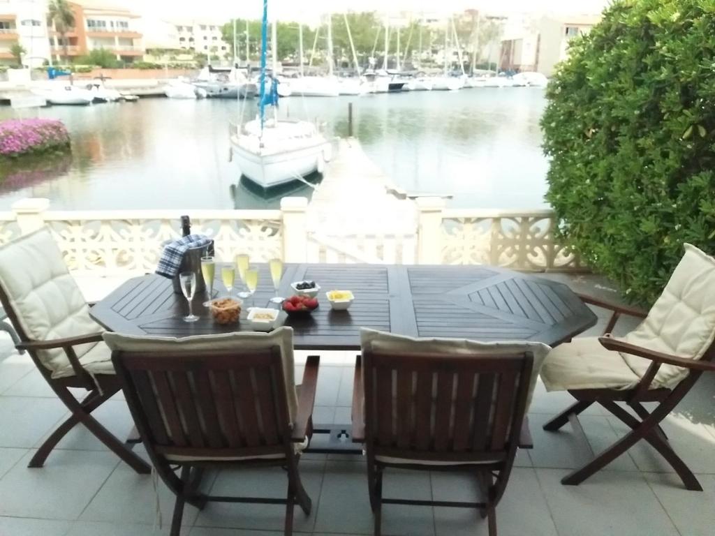 a table and chairs on a patio with a view of the water at MARINA in Cap d'Agde