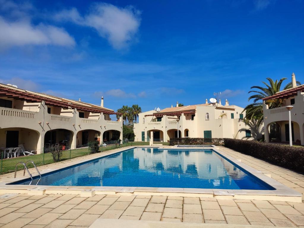 a swimming pool in front of a house at 61 Casa Pitta Manau - Casas & Papéis in Porches