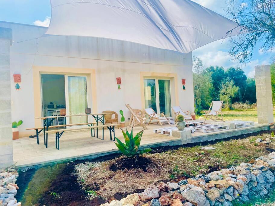 a house with a porch with chairs and a patio at Ca’ dell’Agave-Le more-Villa immersa negli ulivi in Surano