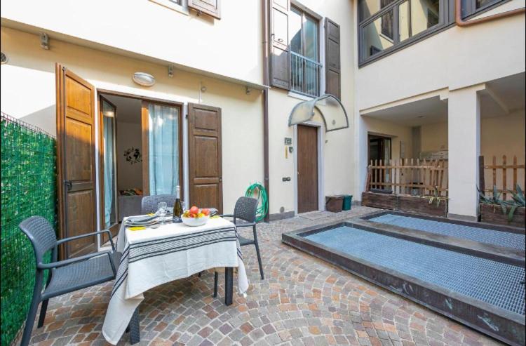 a patio with a table and chairs and a pool at 1Dest - La Corte in Riva del Garda