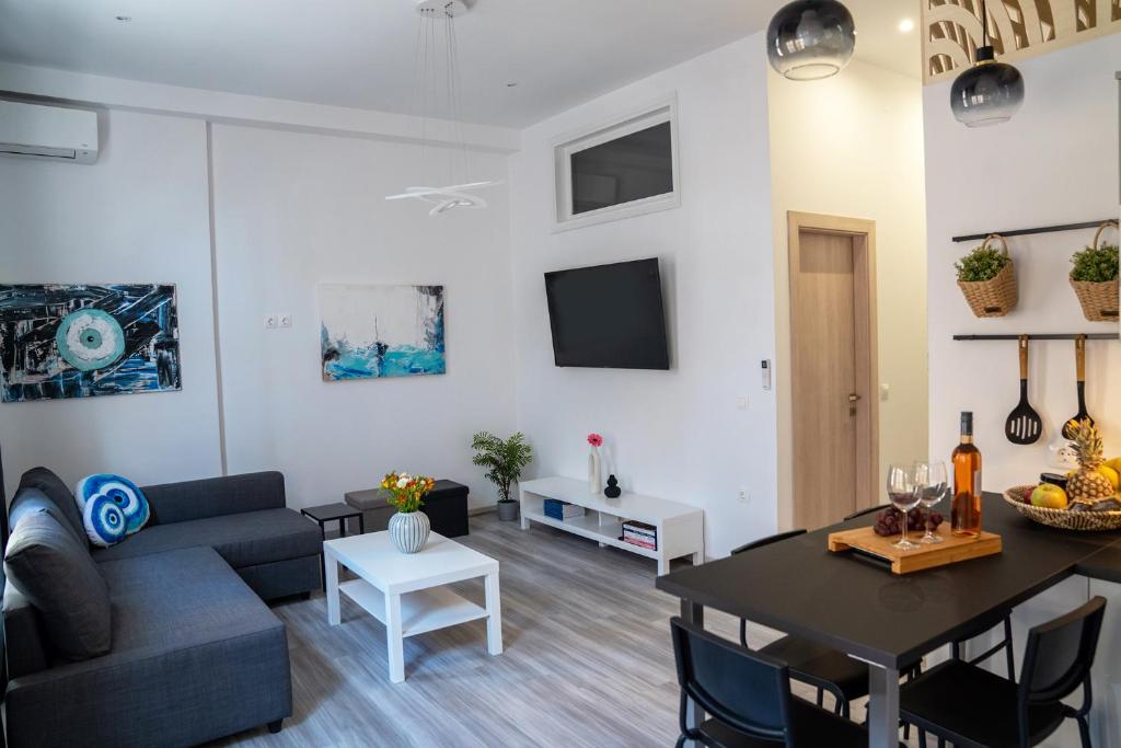 a living room with a couch and a table at Central Suites Aegina 2 in Aegina Town