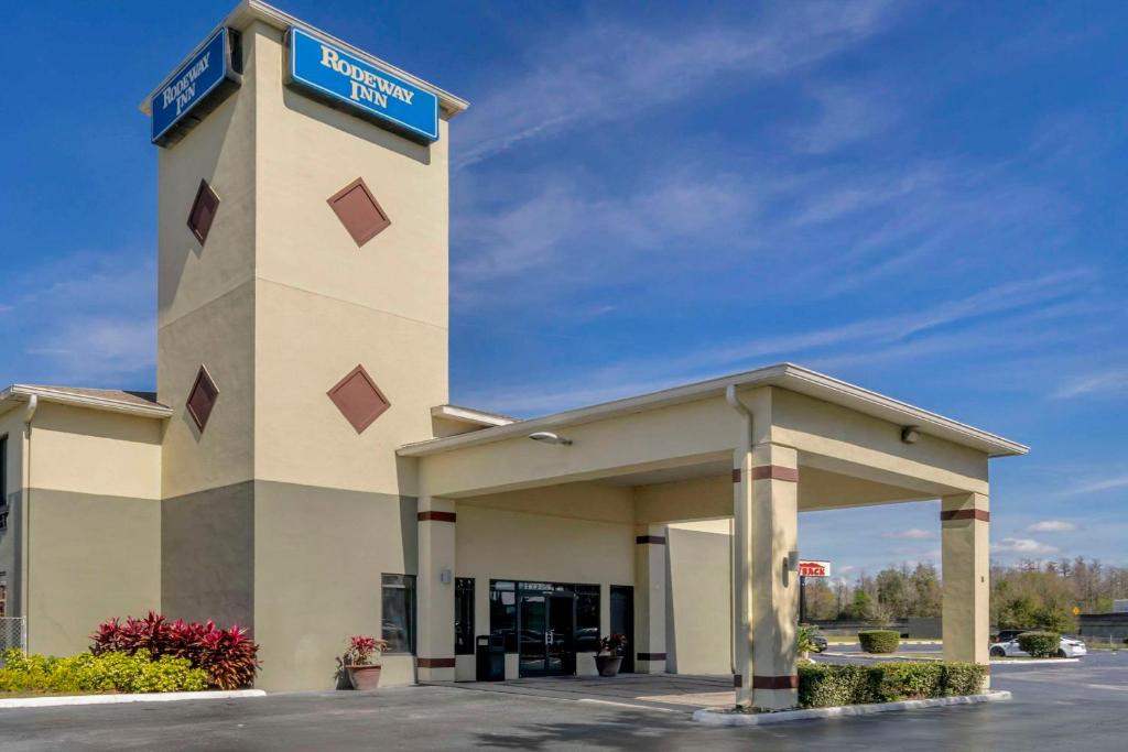 a building with a sign on top of it at Rodeway Inn Wesley Chapel in Wesley Chapel