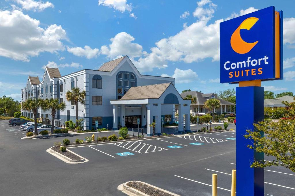 a sign for a comfort suites in a parking lot at Comfort Suites Southport - Oak Island in Southport