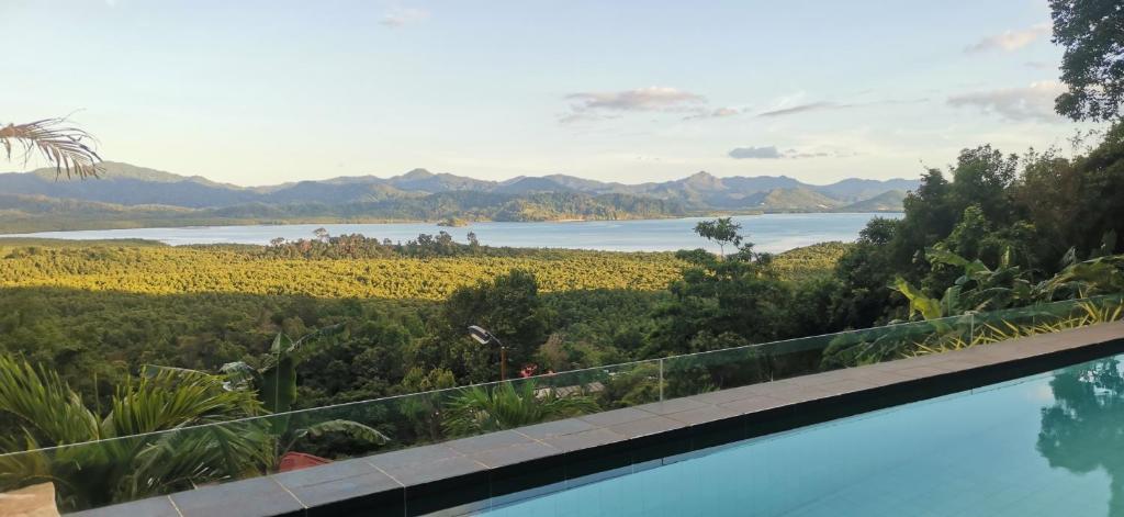 a swimming pool with a view of a lake and mountains at RC Villas and Resorts in El Nido