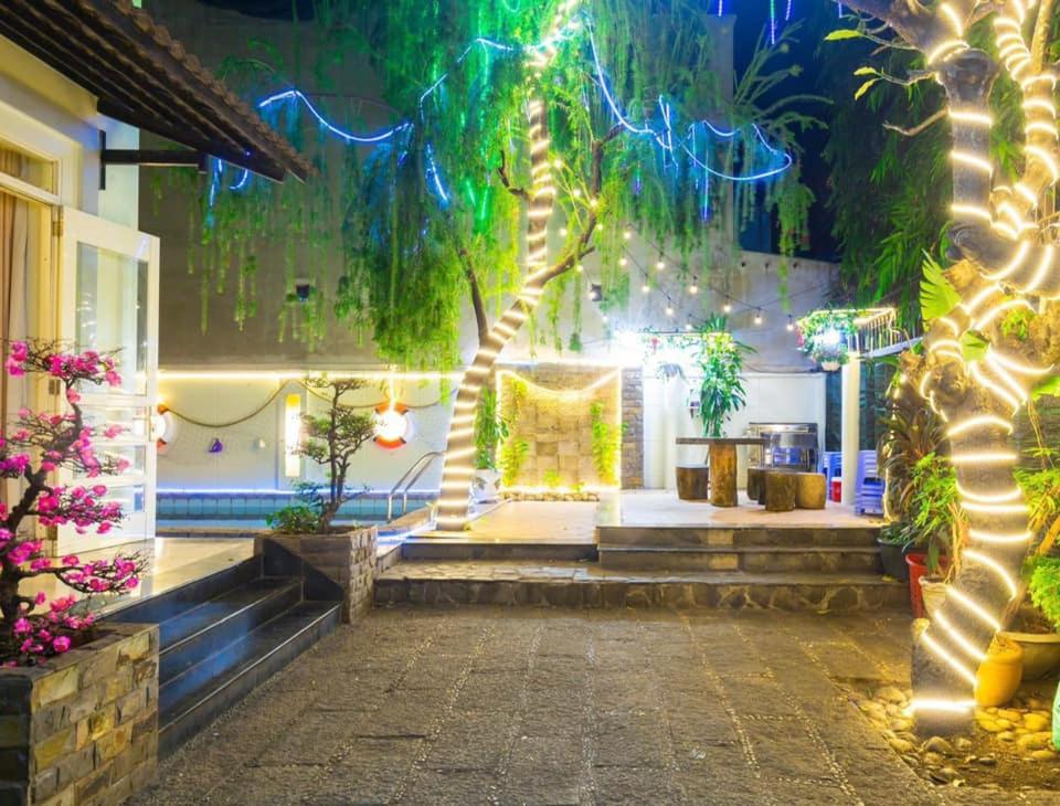 a room with a tree with lights and stairs at 22 ba trieu phuong 1 thanh pho vung tau in Vung Tau