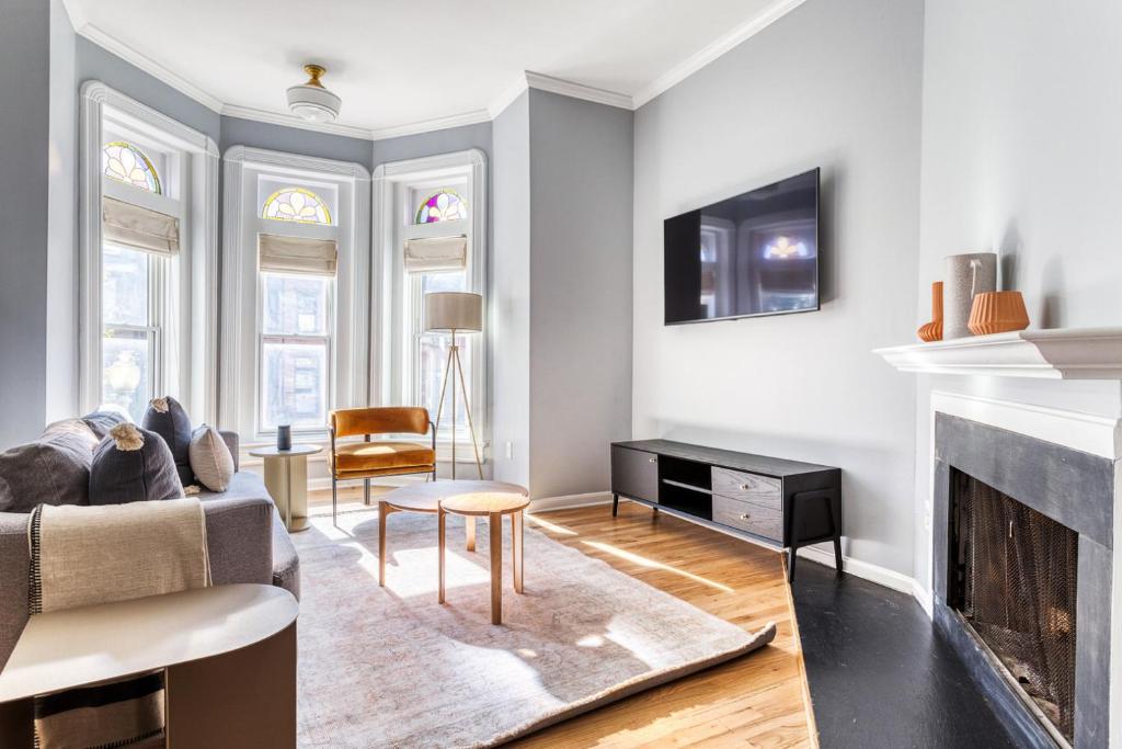 a living room with a couch and a fireplace at Dupont 2BR w Patio WD nr nightlife WDC-340 in Washington, D.C.