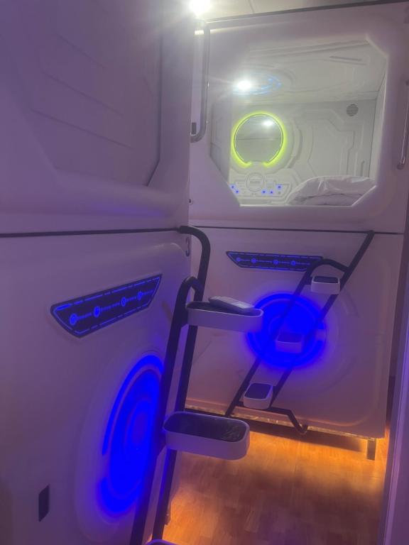 an open refrigerator with blue lights in it at Limin Hostel Capsules in Valencia