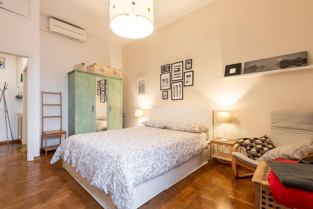 a bedroom with a bed and a chair in it at Casa al 4 in Florence