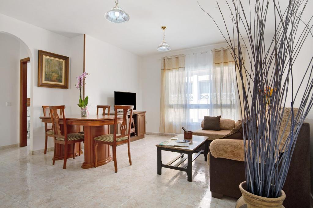 a living room with a couch and a table and chairs at Casa Rosi in Gran Tarajal