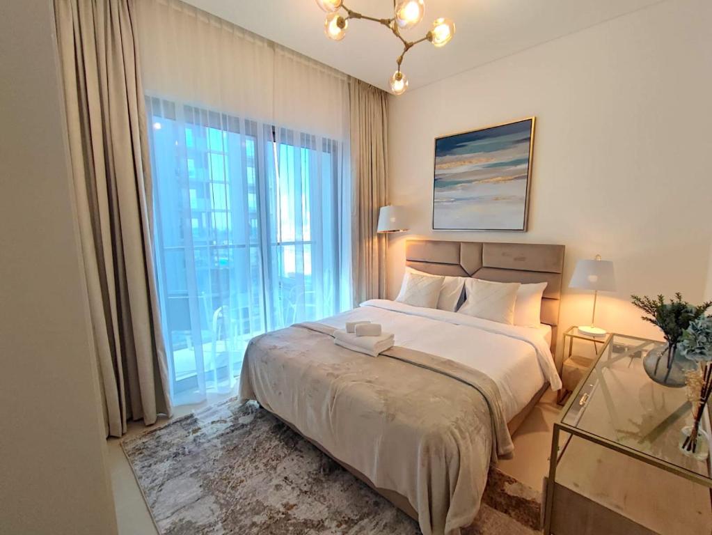 a bedroom with a large bed and a large window at Perfect 1 BR for Family Stay - Close to Downtown in Dubai