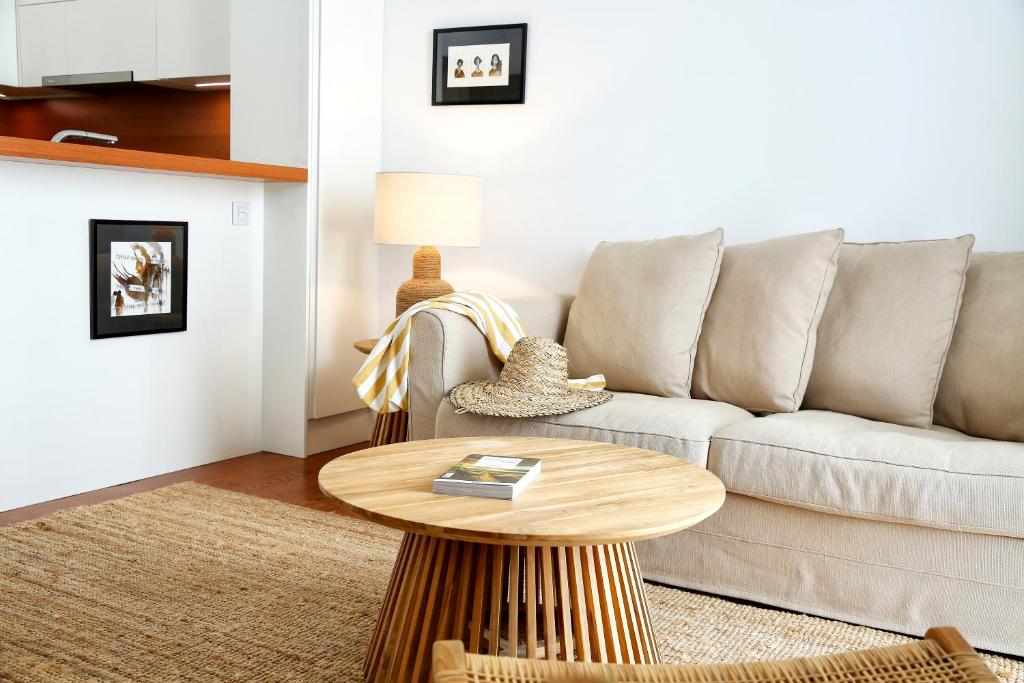 a living room with a couch and a table at Algarve Sweetness Apartment in Faro