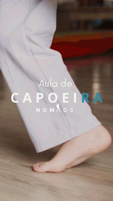 a persons leg in a white dress on the floor at Nomads Hostel Multicultural & Coworking in Salvador