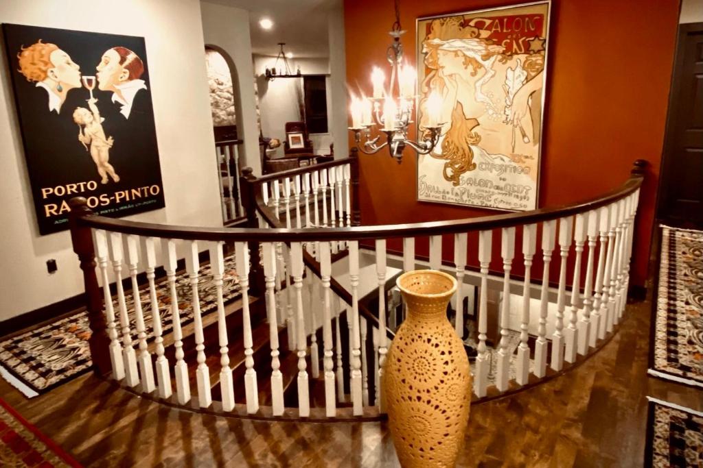 a spiral staircase with a vase on the floor at Neocolonial Nouveau Kensington in Vancouver