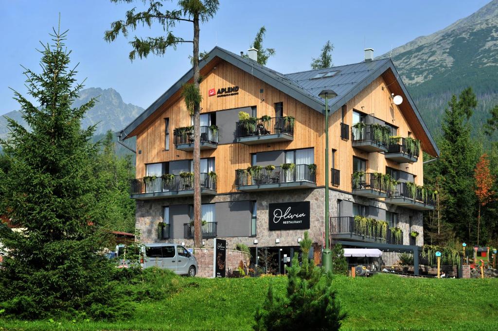 a large building with balconies on the side of it at APLEND Vila Olívia in Vysoke Tatry - Novy Smokovec