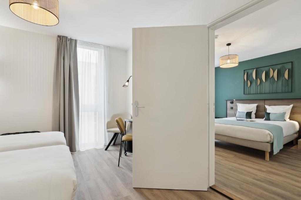 Posteľ alebo postele v izbe v ubytovaní All Suites Noisy Le Grand