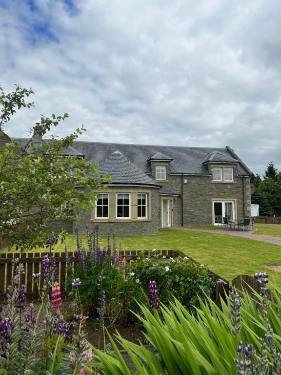 a house with a garden in front of it at Rohallian in Stanley