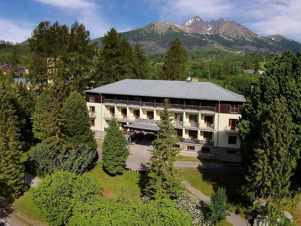 an aerial view of a building with mountains in the background at APLEND Hotel Lujza Major in Vysoke Tatry - Tatranska Lomnica.