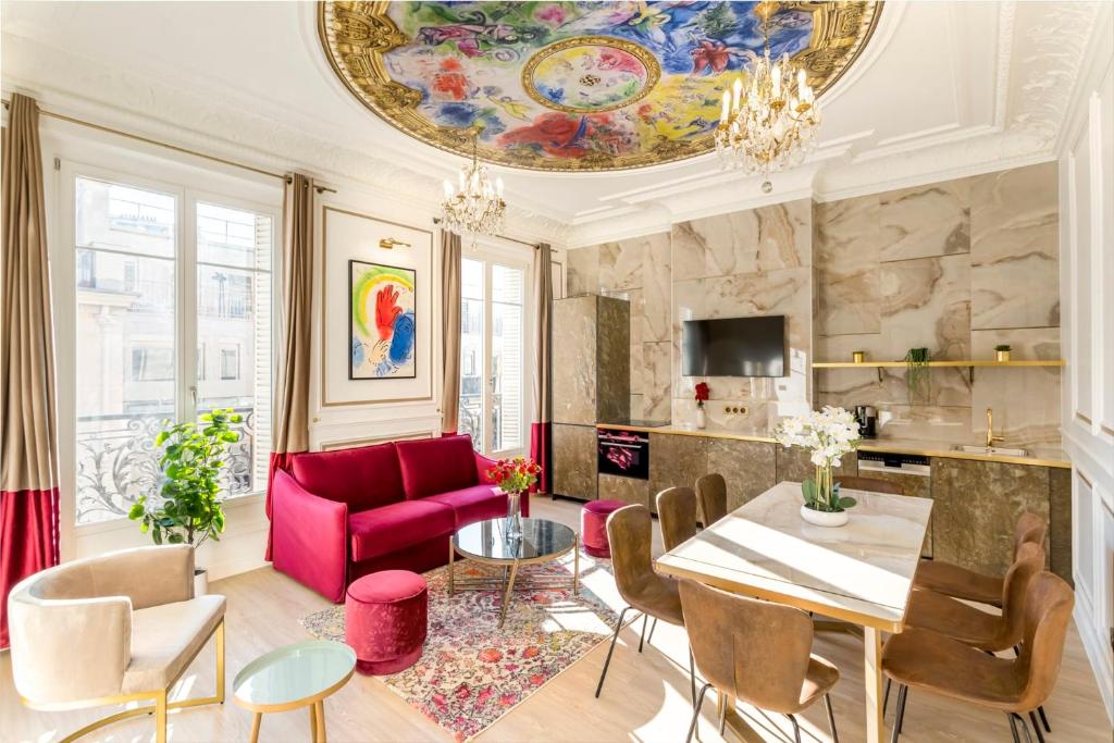 a living room with a pink couch and a table at Luxury 3 Bedrooms 2 Bathrooms Apartment - Opera Louvre in Paris