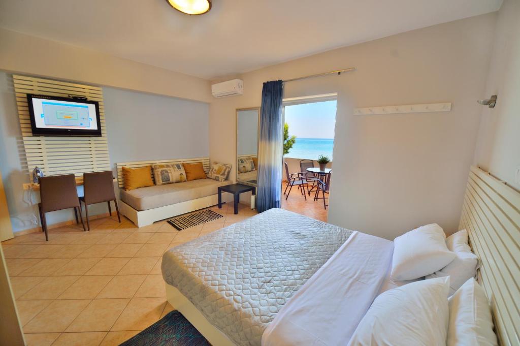 een hotelkamer met een bed en een woonkamer bij Wink Bnb Paraliaki in Kissamos