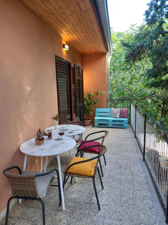 a patio with two tables and chairs on a balcony at Summer Dream in Rovinj