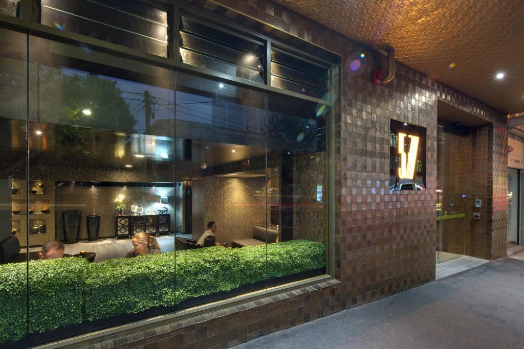 a window of a restaurant with people sitting in it at 57Hotel in Sydney