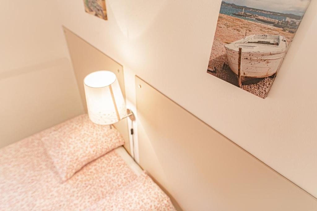 a bedroom with a bed with a picture on the wall at Domaine De Sigalous in La Crau