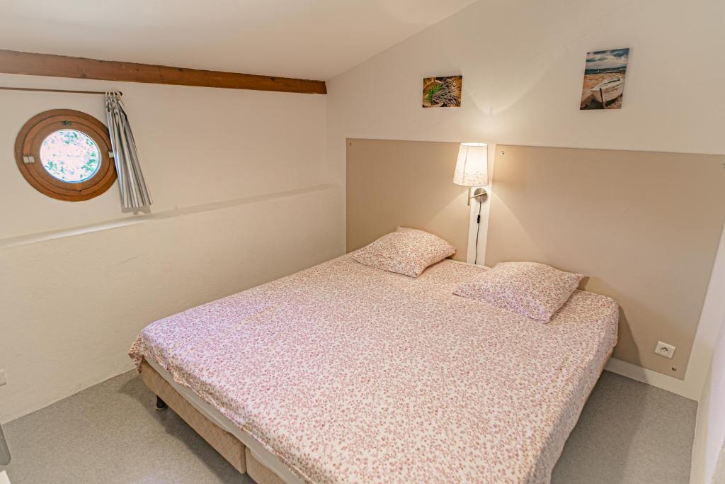 a small bedroom with a bed and a window at Domaine De Sigalous in La Crau