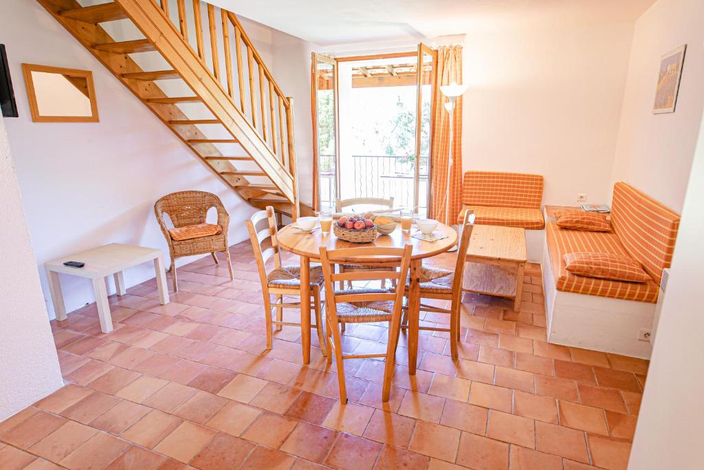 a dining room with a table and chairs at Domaine De Sigalous in La Crau
