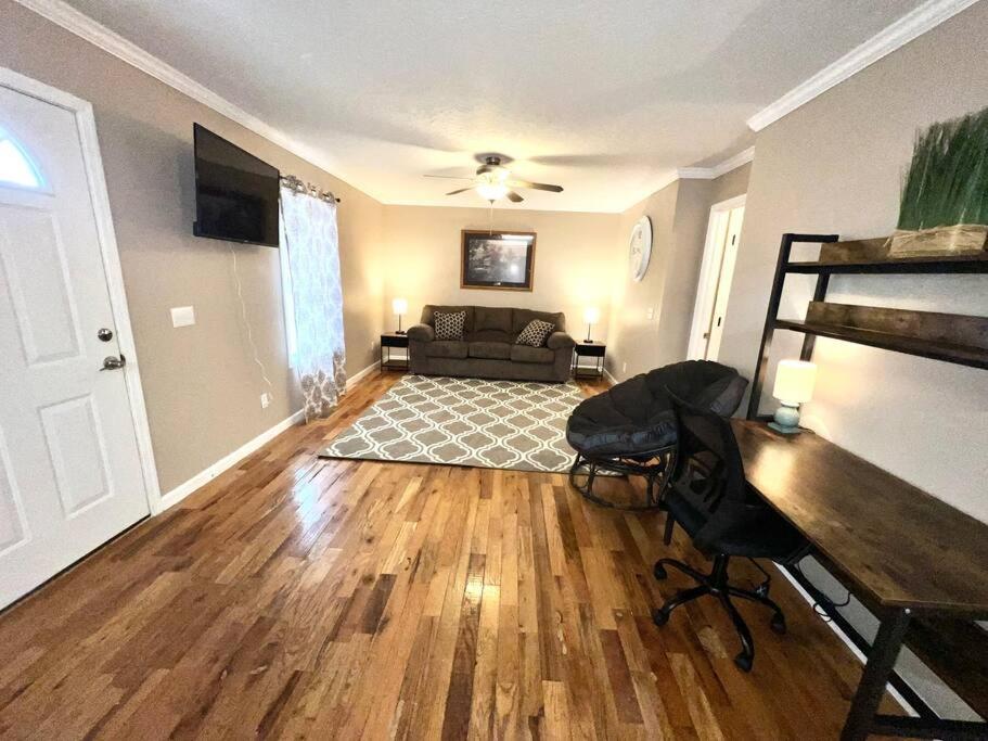 a living room with a couch and a piano at Peaceful Townhouse Near Lake in Guntersville