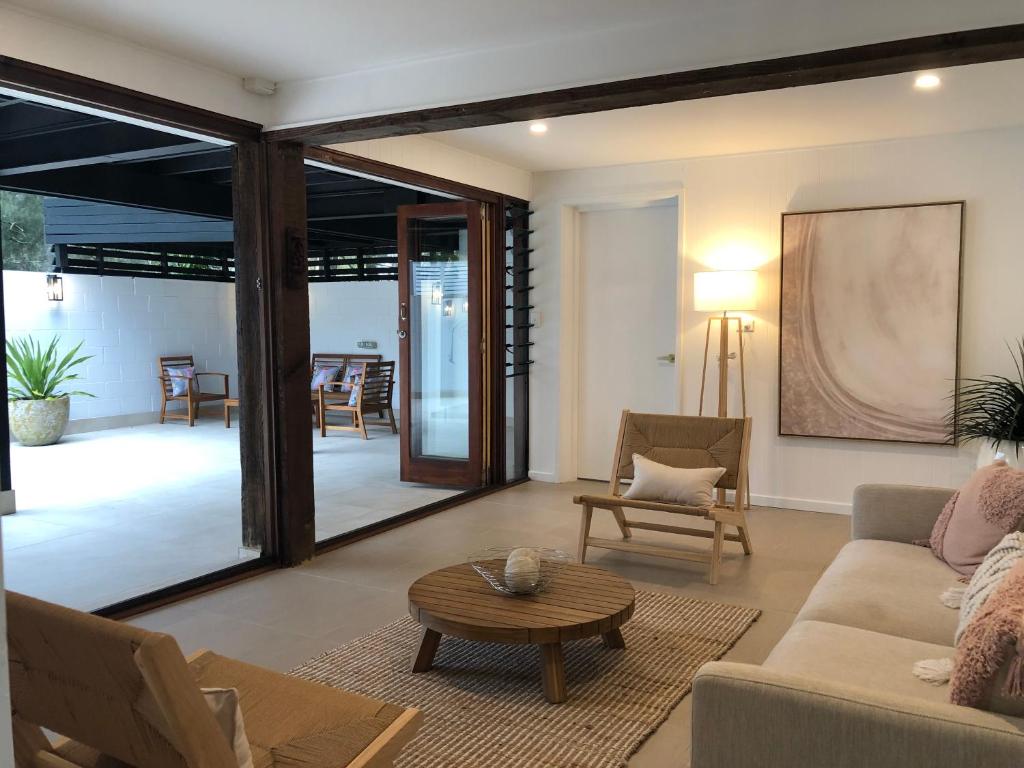 a living room with a couch and a table at The COCO in The Entrance