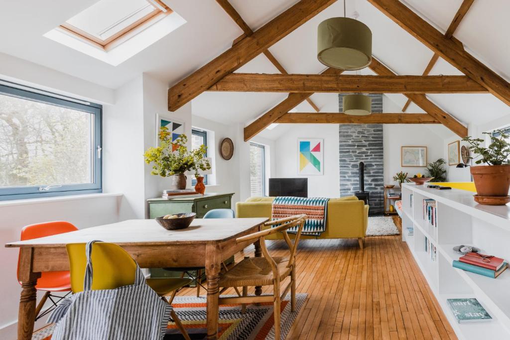 a kitchen and dining room with a table and chairs at The Red Barn at Venn Farm - Gorgeous Upside-Down Barn on Smallholding Near Cornish Surf Beaches in Bude