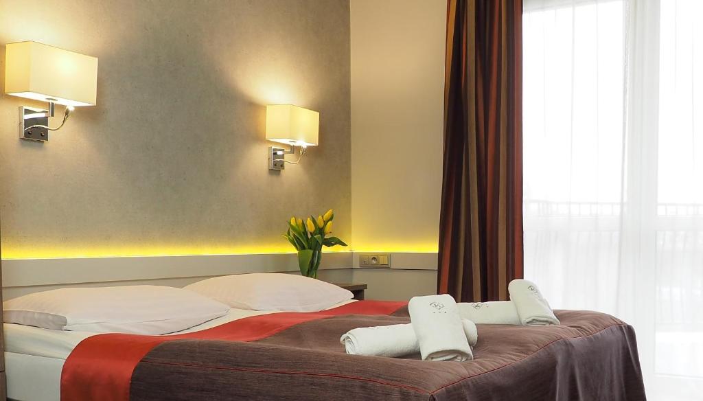 Łóżko lub łóżka w pokoju w obiekcie Hotel Konstancja