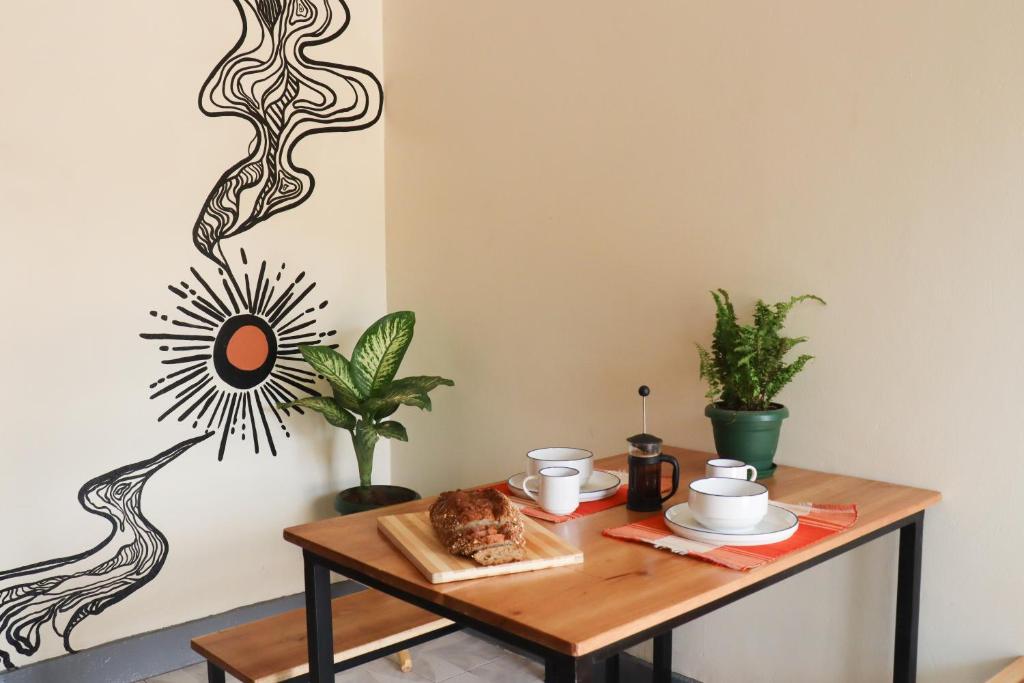 a table with a plate of food on it at Charming 2-Bed House in Kampala in Kampala