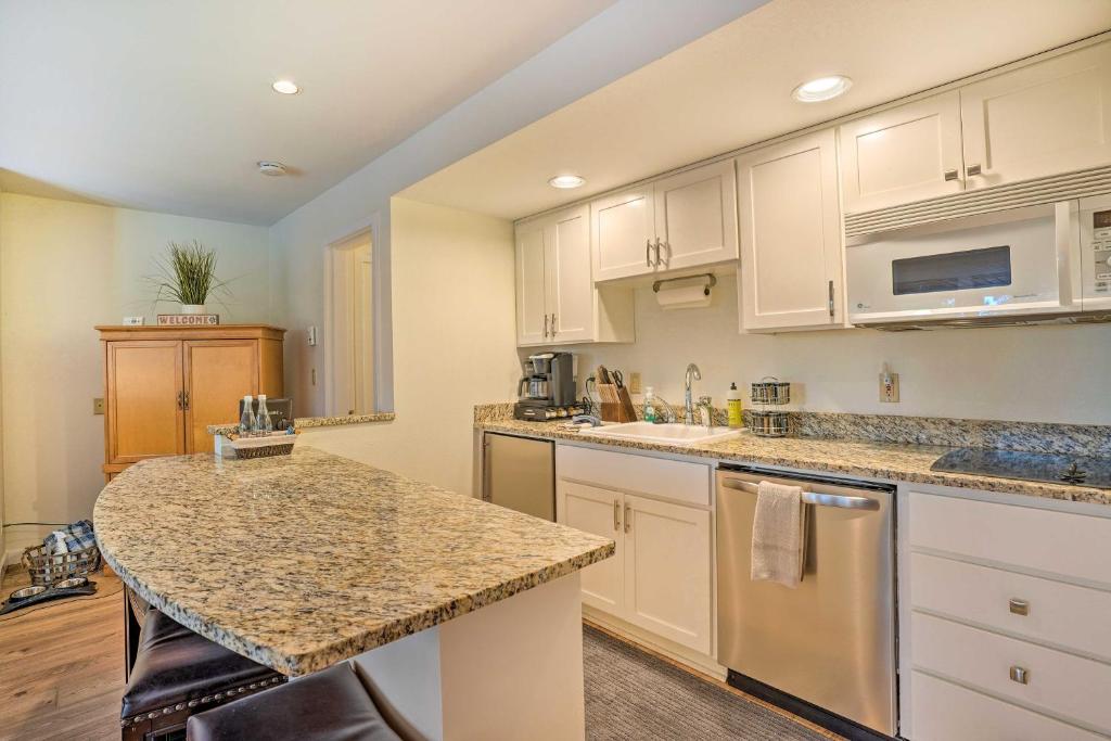a kitchen with white cabinets and a granite counter top at Seventh Mountain Condo with Resort Amenities! in Bend