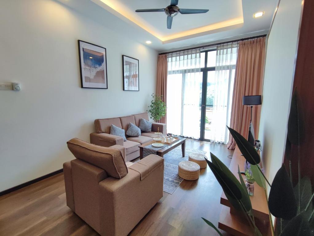 a living room with a couch and a table at Muji Homestay @ The Retreat, Cameron Highlands in Cameron Highlands