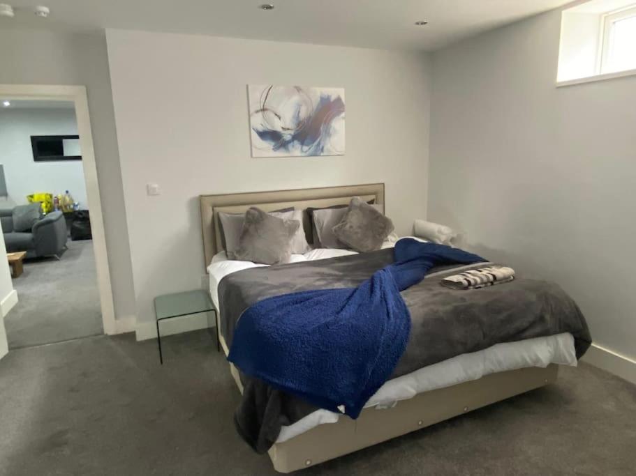 a bedroom with a bed with a blue blanket on it at 10 St Andrews in Lytham St Annes