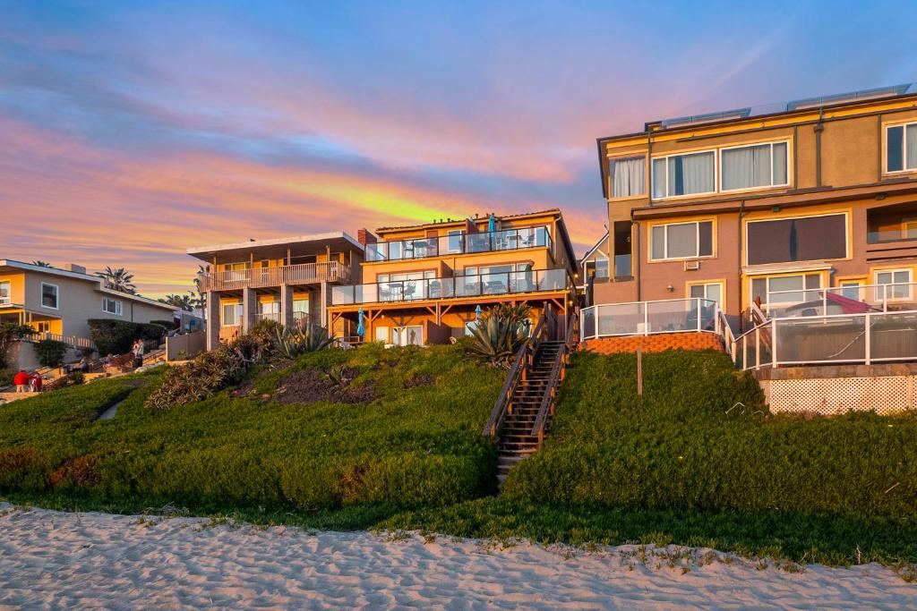 a building on the beach with a sunset in the background at 3009 Ocean Street in Carlsbad