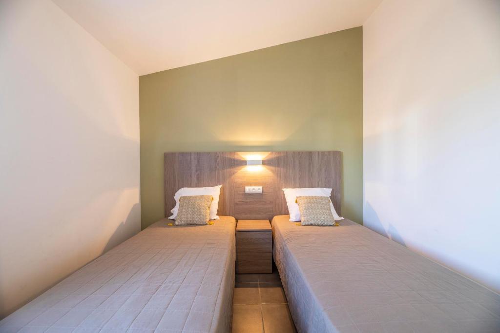a bedroom with two beds in a room at Résidence Santa Monica in Bonifacio