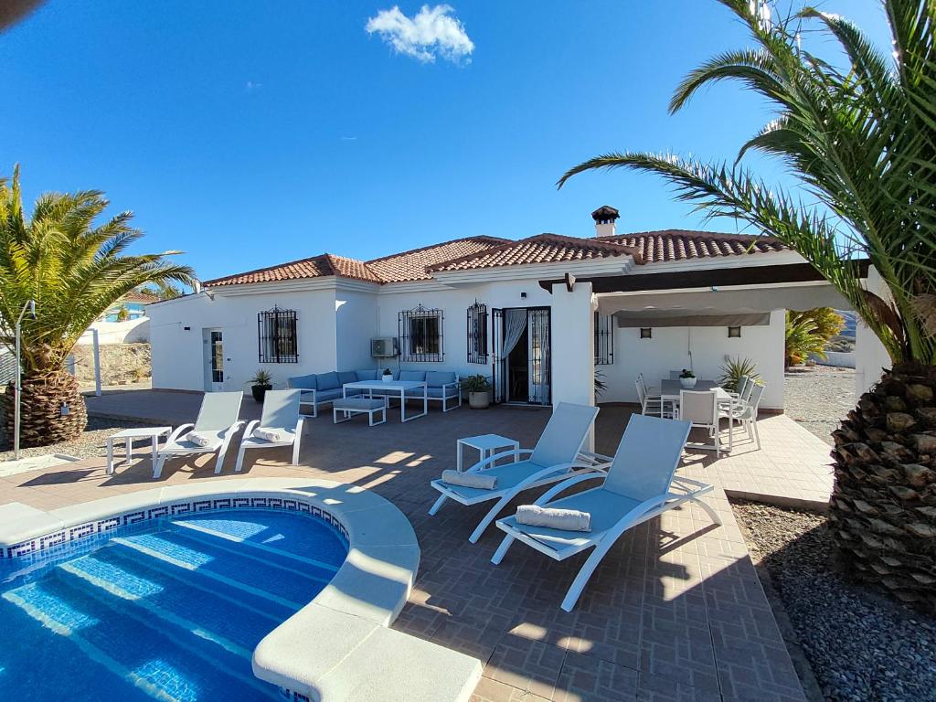 a villa with a swimming pool and a house at Villa Alta Vista in Albox