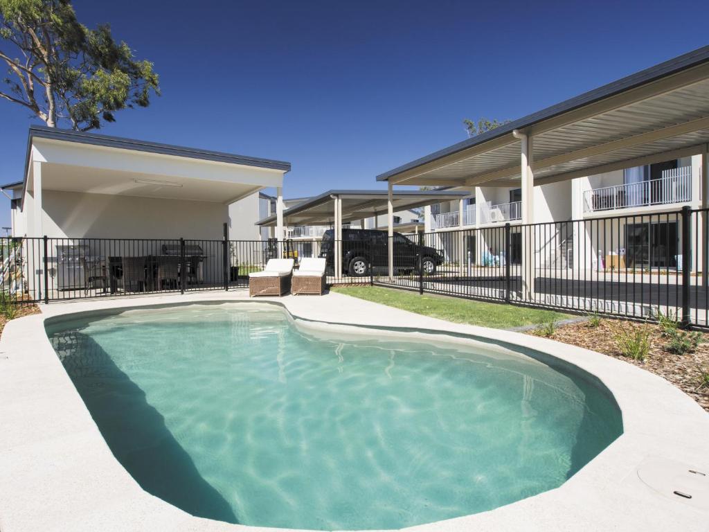 a swimming pool in front of a house at Oaks Middlemount Suites in Middlemount