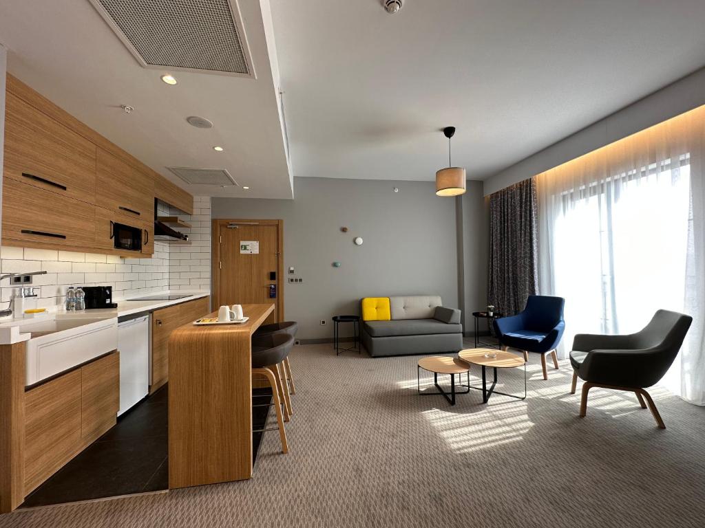 a room with a kitchen and a living room at Holiday Inn Express - Ankara - Airport by IHG in Ankara