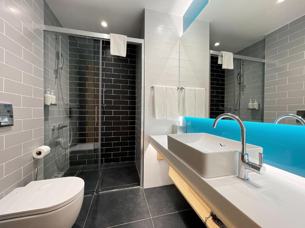 a bathroom with a toilet and a sink and a shower at Holiday Inn Express - Ankara - Airport by IHG in Ankara