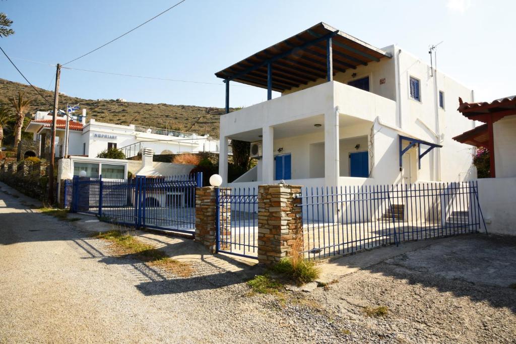 a white house with a fence in front of it at Andros 2 berdrooms 4 persons cycladic house. in Kypri