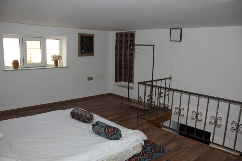 a bedroom with a white bed and a staircase at East in Baku
