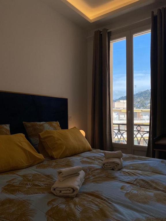 sypialnia z dużym łóżkiem z ręcznikami w obiekcie PALACE ROOM CROISETTE w Cannes