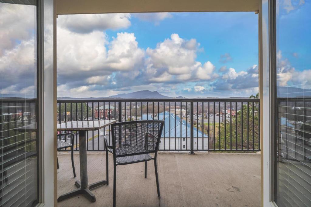 a balcony with a table and chairs and a view at MVC - Unit 1305 in Pigeon Forge